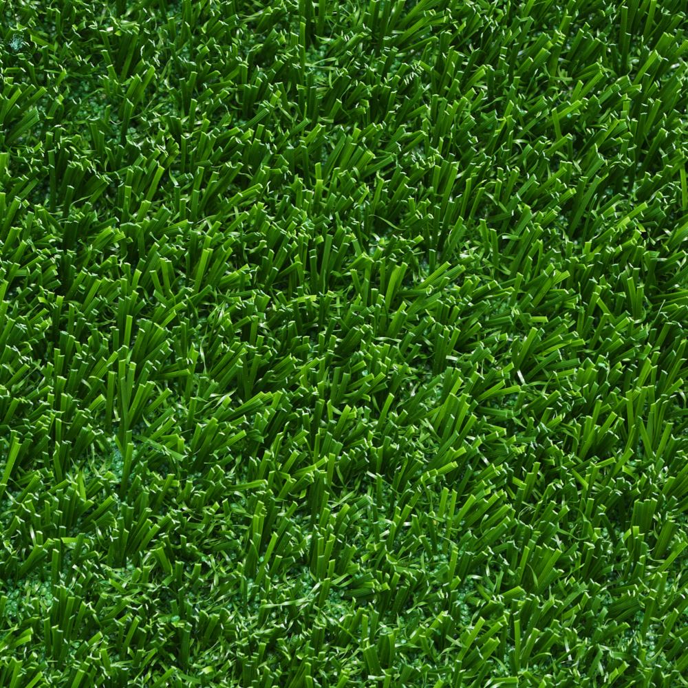 Close up image of artificial grass that is bright green.